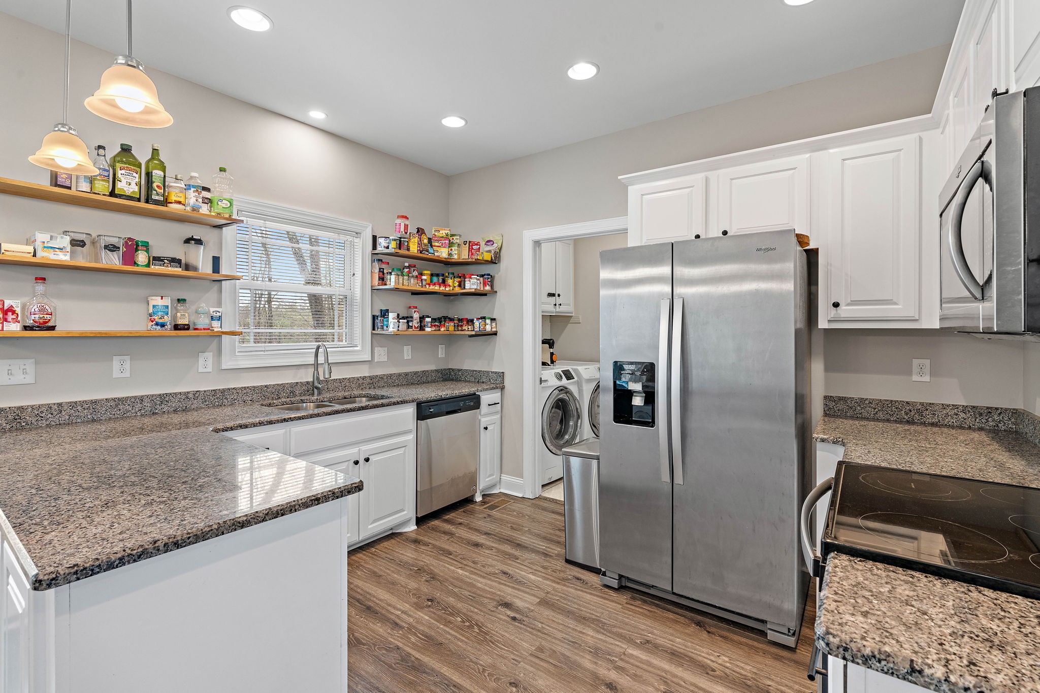 4233 Old Coopertown Road Springfield, TN 37172 - Photo 9 of 28 a kitchen with stainless steel appliances granite countertop a refrigerator a stove and a sink with wooden floor