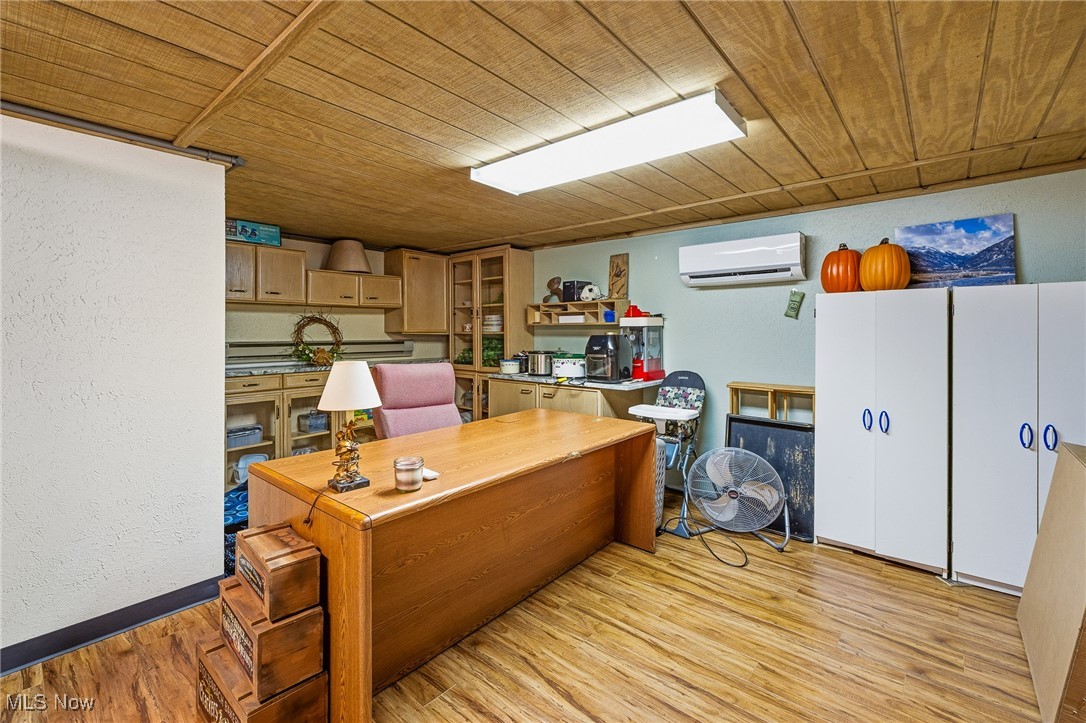 86523 North Bay Road Scio, OH 43988 - Photo 14 of 25 Home office featuring a textured wall, light wood-type flooring, wooden ceiling, and a wall mounted AC