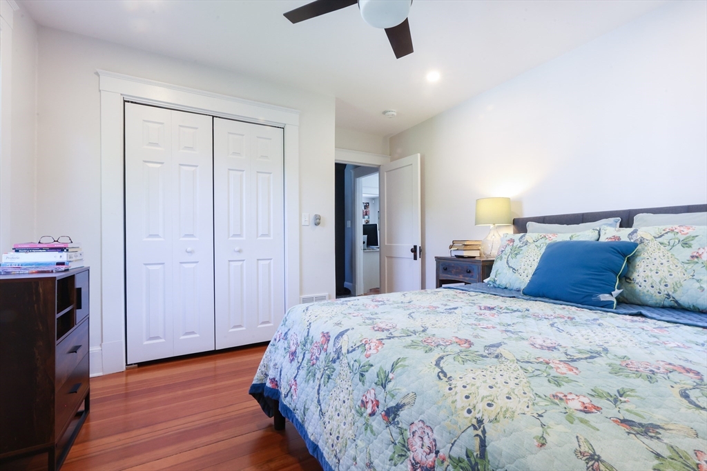 22 Stubb Street, Unit 1 Franklin, MA 02038 - Photo 15 of 42 a bedroom with a bed and a chandelier