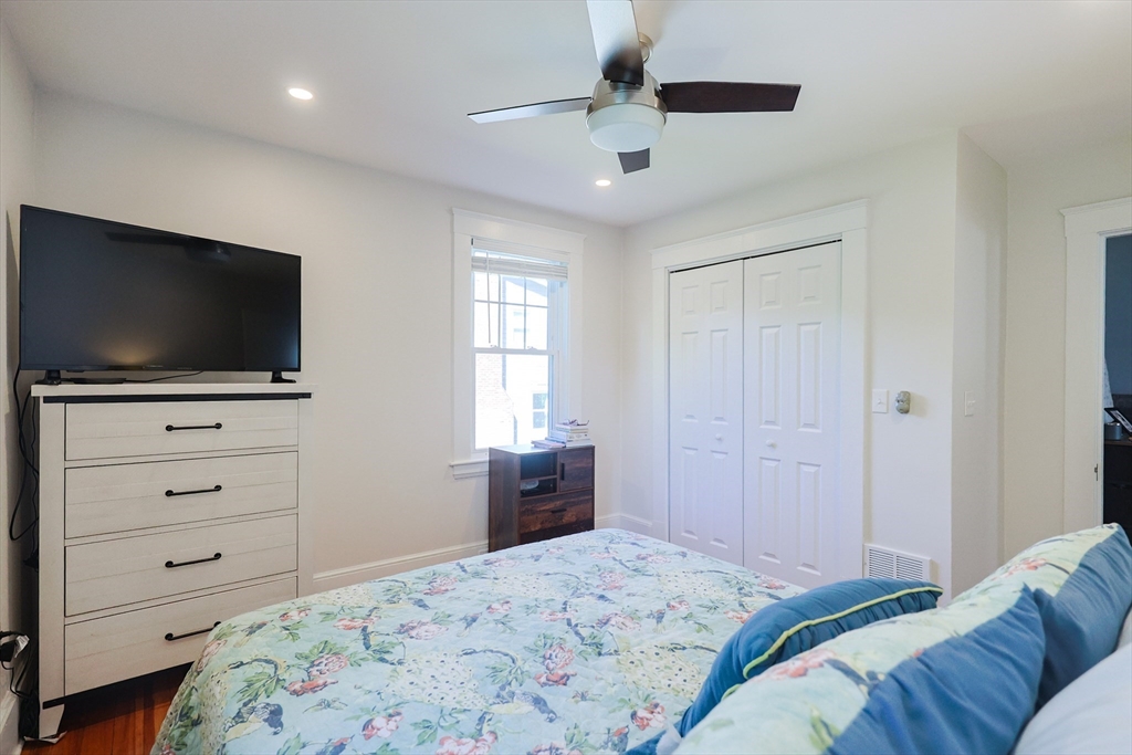 22 Stubb Street, Unit 1 Franklin, MA 02038 - Photo 16 of 42 a bedroom with a bed and a flat screen tv