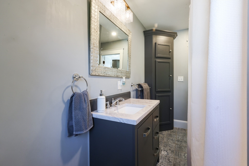 22 Stubb Street, Unit 1 Franklin, MA 02038 - Photo 18 of 42 a bathroom with a sink vanity and mirror
