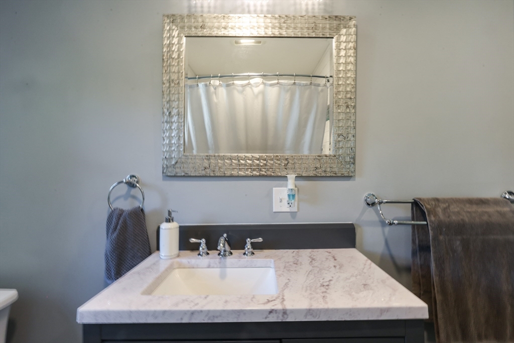 22 Stubb Street, Unit 1 Franklin, MA 02038 - Photo 19 of 42 a bathroom with a sink and a mirror