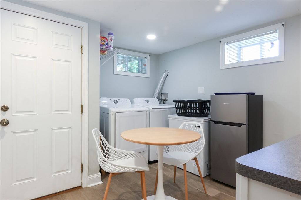 22 Stubb Street, Unit 1 Franklin, MA 02038 - Photo 20 of 42 a kitchen with stainless steel appliances a refrigerator and a table