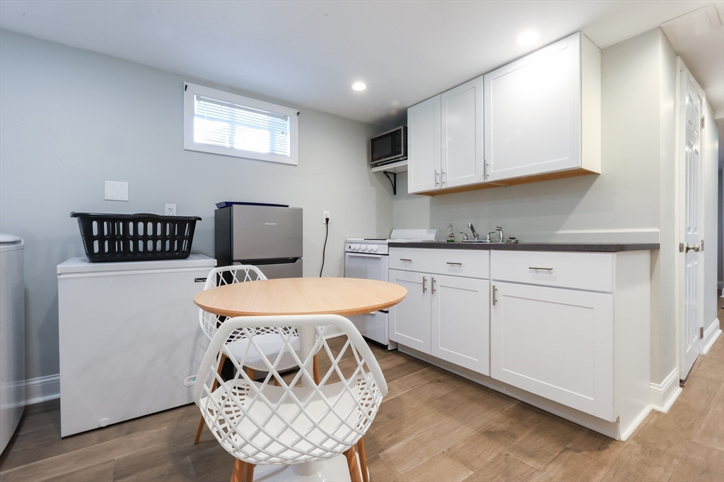 22 Stubb Street, Unit 1 Franklin, MA 02038 - Photo 21 of 42 a kitchen with a sink a stove a refrigerator and cabinets
