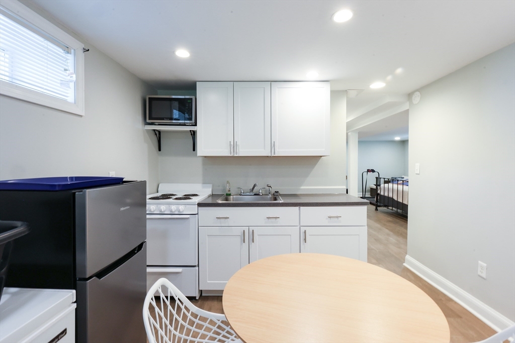 22 Stubb Street, Unit 1 Franklin, MA 02038 - Photo 22 of 42 a kitchen with stainless steel appliances granite countertop a sink stove and cabinets
