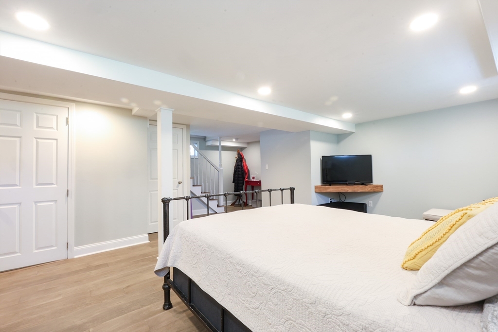 22 Stubb Street, Unit 1 Franklin, MA 02038 - Photo 28 of 42 a bedroom with a bed and a flat screen tv