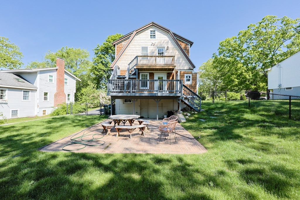 22 Stubb Street, Unit 1 Franklin, MA 02038 - Photo 35 of 42 a view of backyard with table and chairs and potted plants