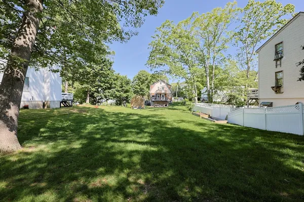 a backyard of a house with lots of green space and fountain
