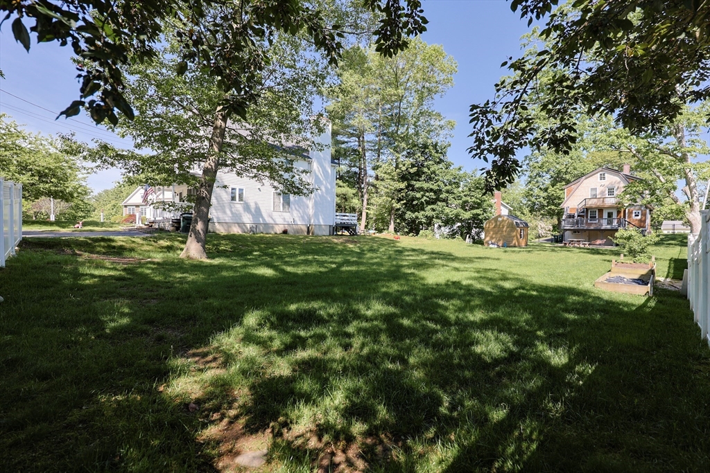 22 Stubb Street, Unit 1 Franklin, MA 02038 - Photo 38 of 42 a backyard of a house with lots of green space and fountain
