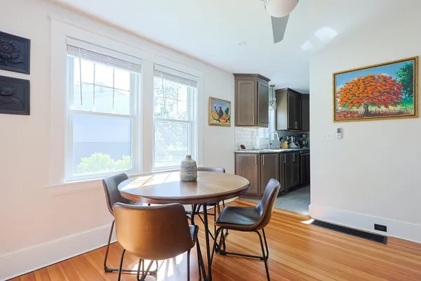 a dining room with furniture and wooden floor