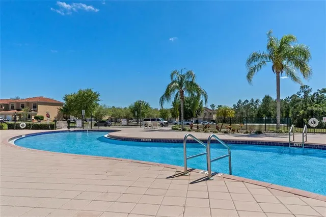 a view of swimming pool with outdoor seating and plants
