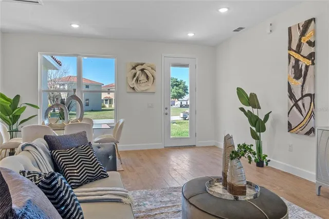 a living room with furniture and a potted plant