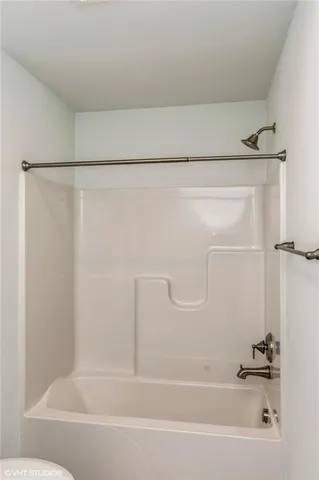 a bathroom with a shower and a bath tub