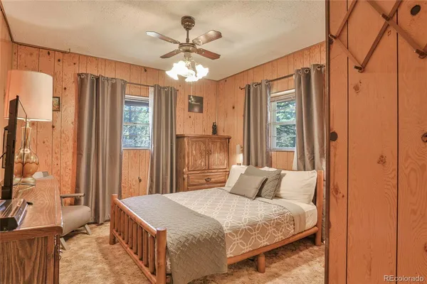 a bedroom with a large bed and a chandelier