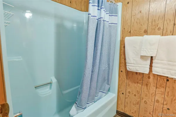 a bathroom with a shower and a tub