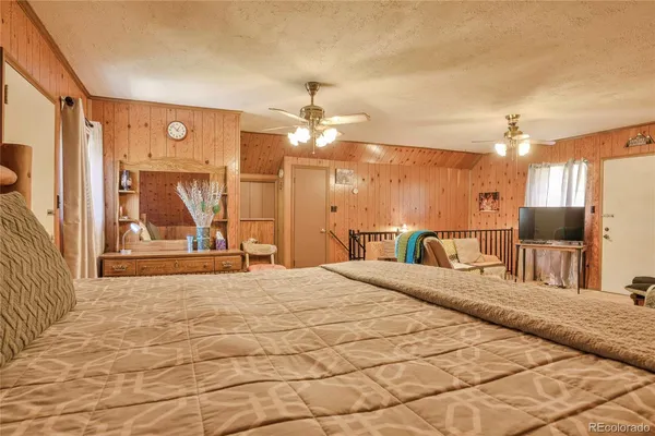 a large bedroom with a bed and a chandelier