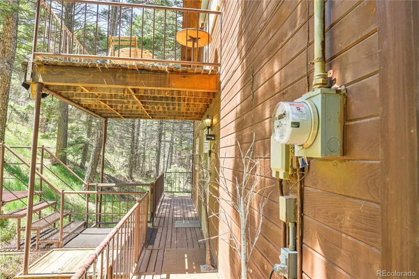 a view of a balcony with wooden floor and door