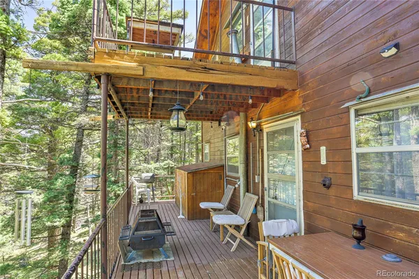 a view of balcony with two chairs and wooden floor