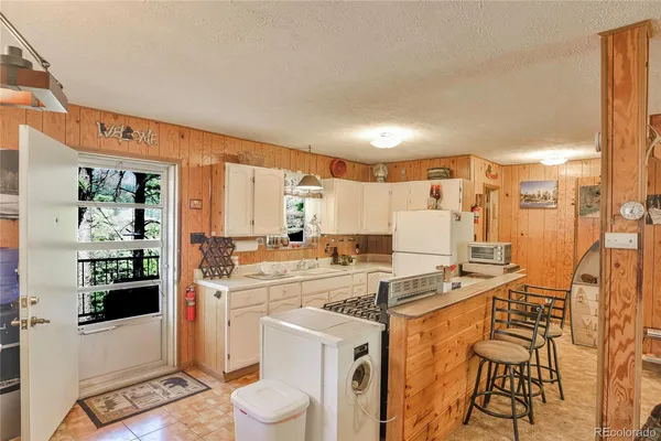 a kitchen with stainless steel appliances a stove a sink and a refrigerator