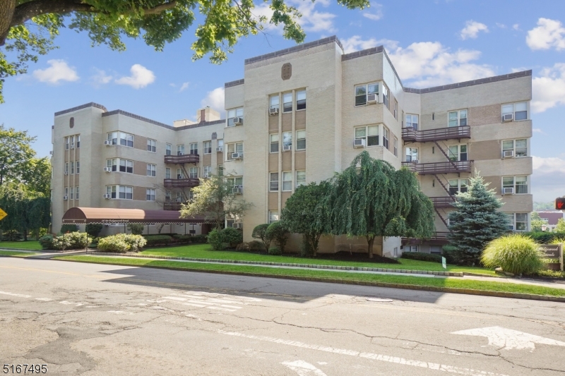 a view of building with yard and green space