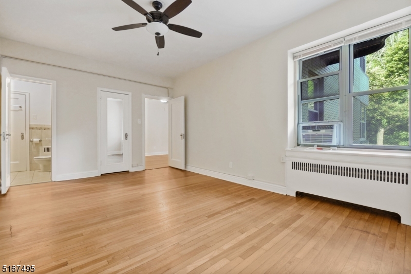 10 North Ridgewood Road, Unit 114 South Orange, NJ 07079 - Photo 11 of 15 a view of an empty room with a window and wooden floor