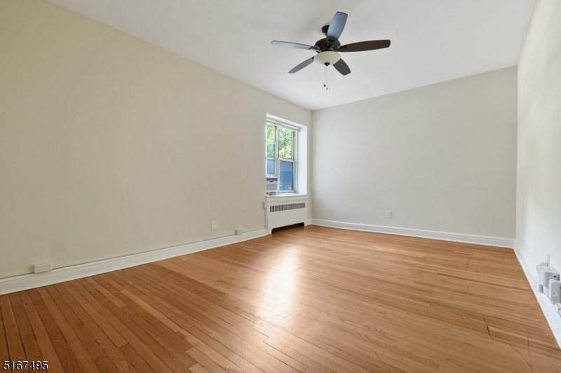 10 North Ridgewood Road, Unit 114 South Orange, NJ 07079 - Photo 13 of 15 an empty room with wooden floor and windows