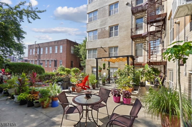 10 North Ridgewood Road, Unit 114 South Orange, NJ 07079 - Photo 14 of 15 a view of a chairs and table in a backyard of a building
