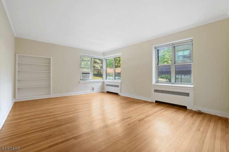 10 North Ridgewood Road, Unit 114 South Orange, NJ 07079 - Photo 5 of 15 a view of an empty room with wooden floor and a window