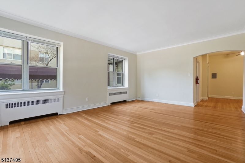 10 North Ridgewood Road, Unit 114 South Orange, NJ 07079 - Photo 6 of 15 a view of an empty room with wooden floor and a window