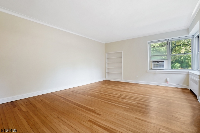 10 North Ridgewood Road, Unit 114 South Orange, NJ 07079 - Photo 7 of 15 a view of an empty room with wooden floor and a window