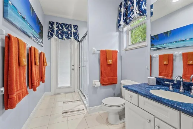 a spacious bathroom with a granite countertop sink toilet and shower