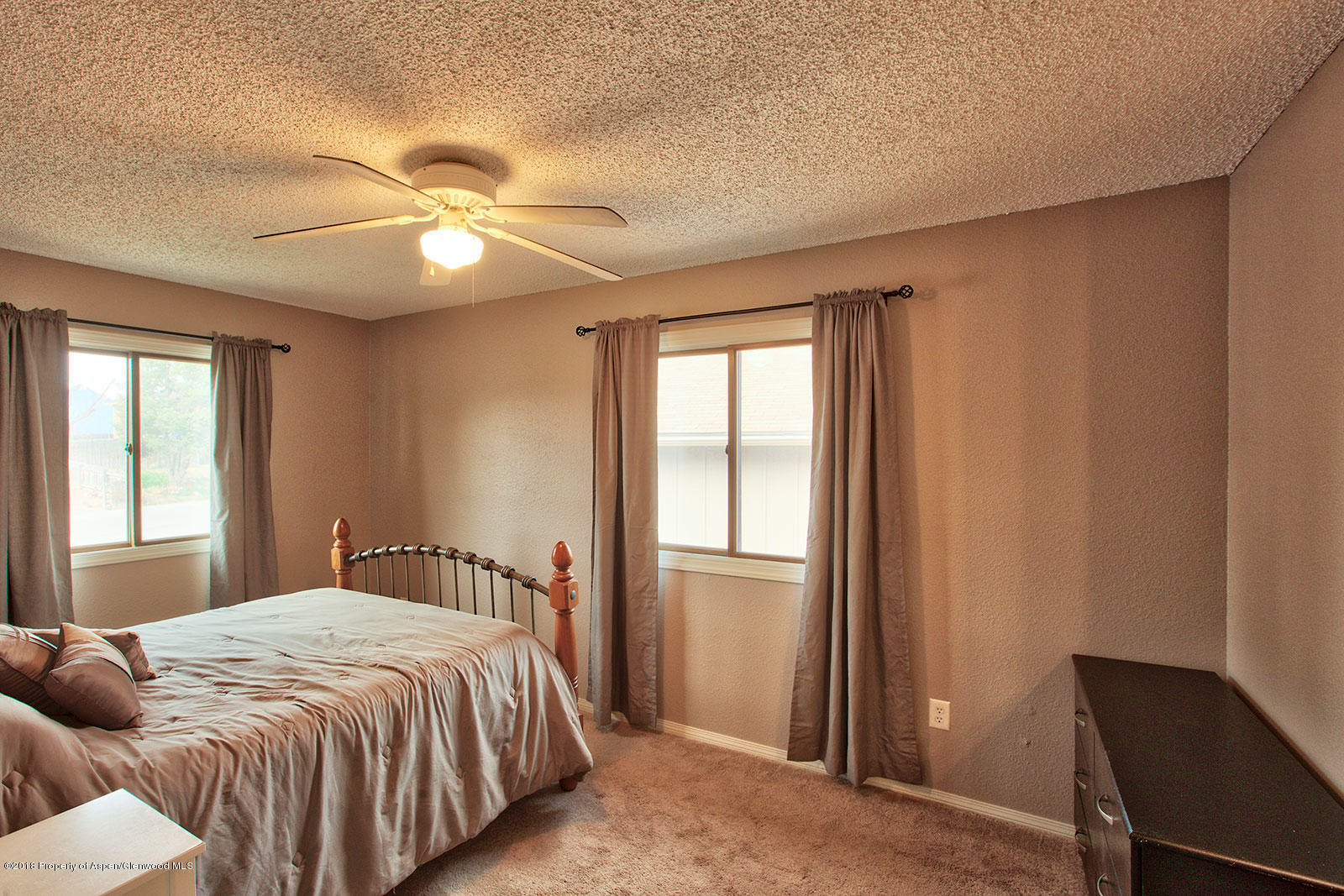 1017 Arnold Court Rifle, CO 81650 - Photo 11 of 28 a bedroom with a large bed and a window