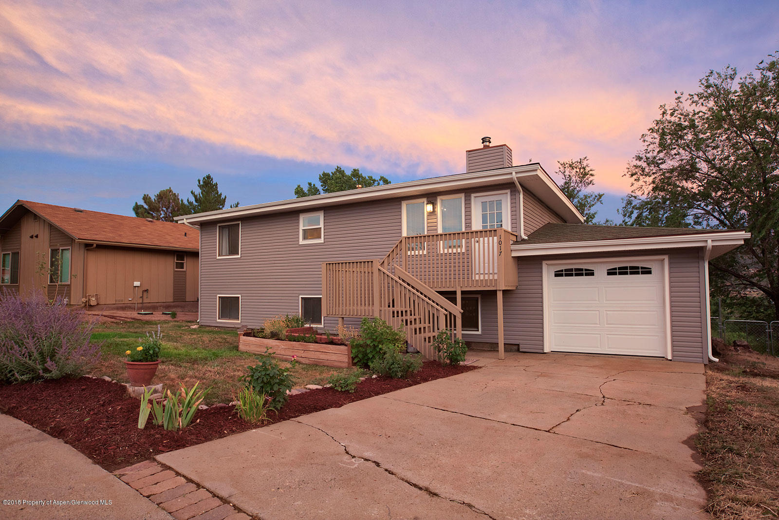 1017 Arnold Court Rifle, CO 81650 - Photo 2 of 28 a front view of a house with a yard and garage