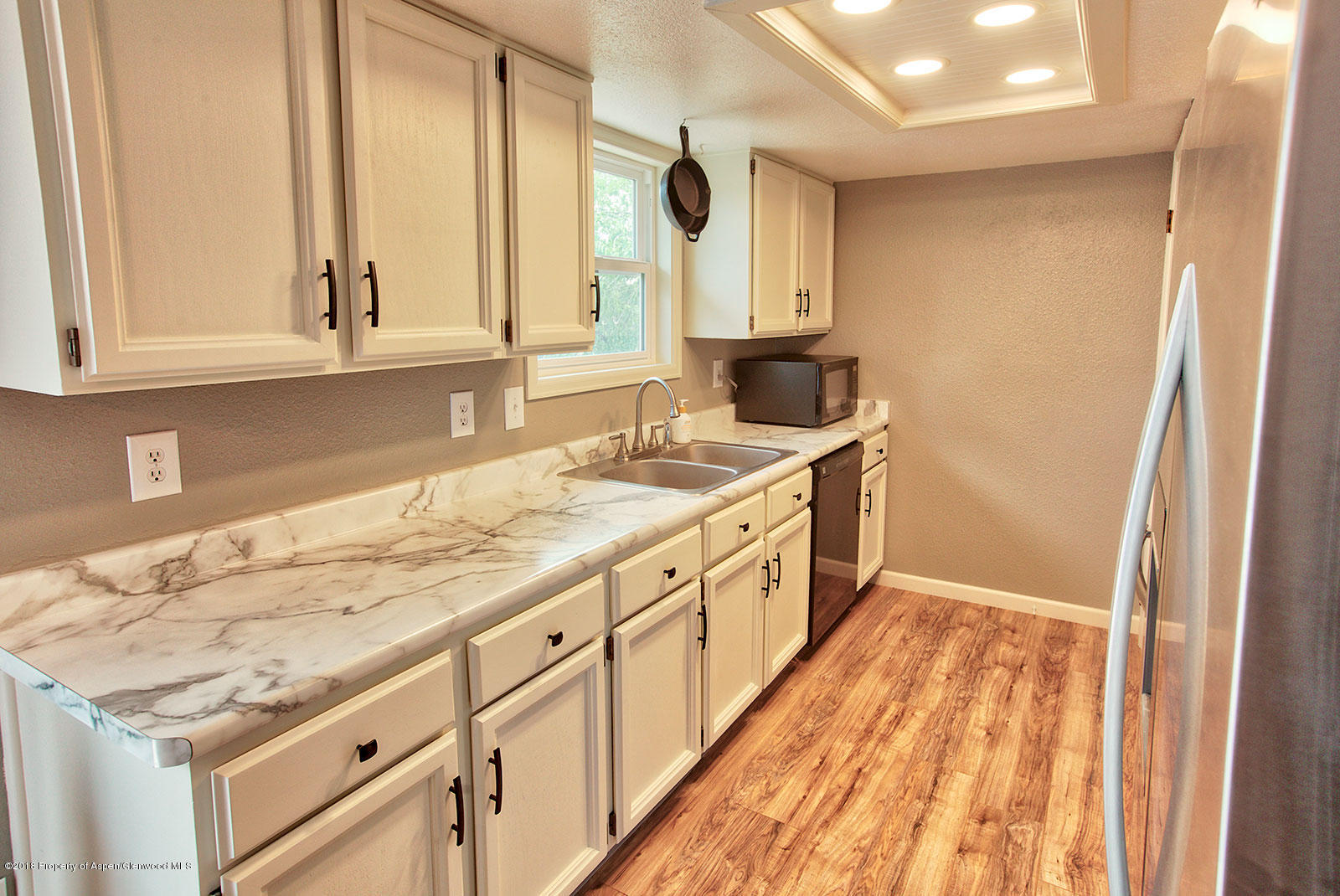 1017 Arnold Court Rifle, CO 81650 - Photo 7 of 28 a bathroom with a granite countertop sink and a mirror