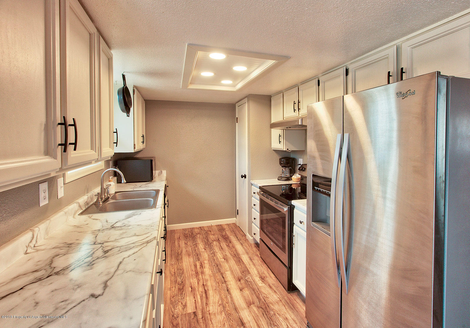 1017 Arnold Court Rifle, CO 81650 - Photo 8 of 28 a kitchen with granite countertop a refrigerator and a sink