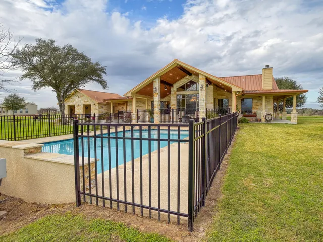 a view of a house with swimming pool and porch