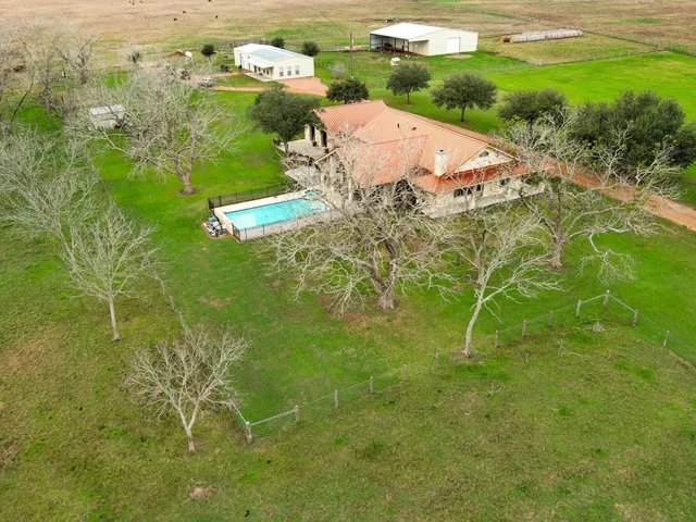 a view of kitchen with stainless steel appliances kitchen island granite countertop a sink and cabinets