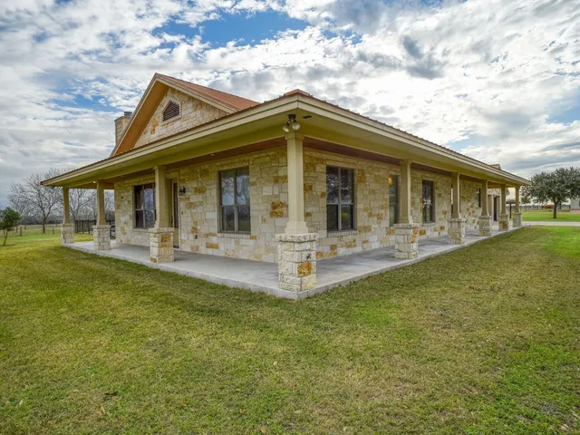 a large kitchen with stainless steel appliances granite countertop a barbecue grill and a sink