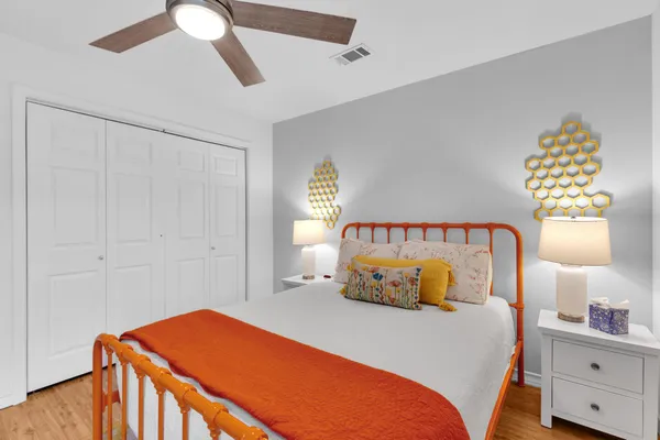 a bedroom with a bed and a chandelier