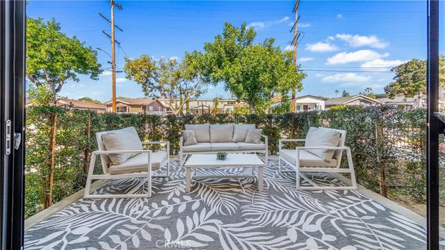 a view of balcony with two chairs and a table