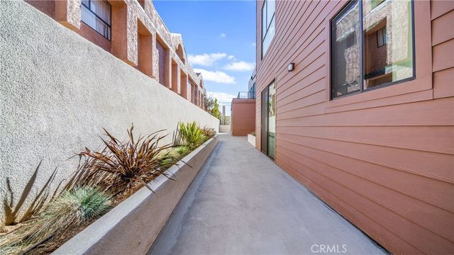 a view of a balcony with flower plants