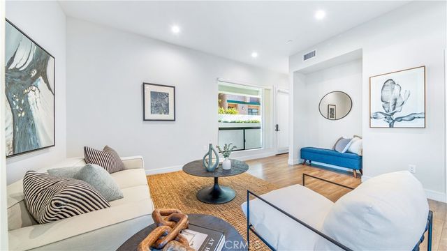 a bedroom with furniture and wooden floor