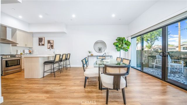 a dining room with furniture a rug and a large window