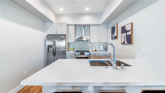 a kitchen with a refrigerator and a sink