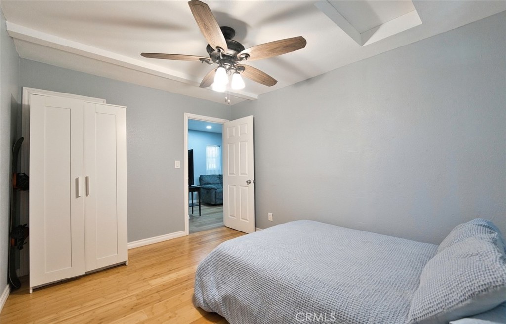 29083 Hook Creek Road Cedar Glen, CA 92321 - Photo 16 of 50 a bedroom with a bed and a chandelier