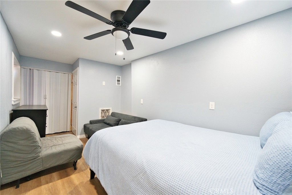 29083 Hook Creek Road Cedar Glen, CA 92321 - Photo 20 of 50 a bedroom with a large bed chandelier and a window