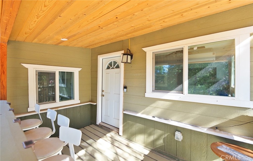 29083 Hook Creek Road Cedar Glen, CA 92321 - Photo 24 of 50 a view of a balcony with chair and table