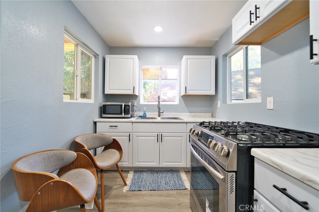 29083 Hook Creek Road Cedar Glen, CA 92321 - Photo 29 of 50 a kitchen with stainless steel appliances granite countertop a stove a sink and a refrigerator