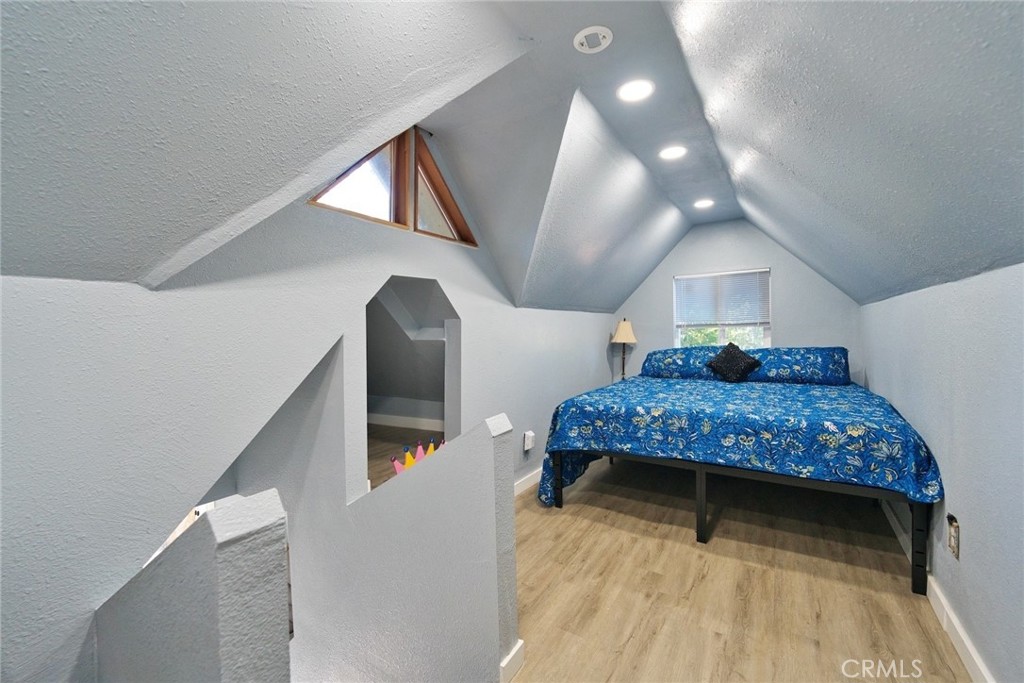 29083 Hook Creek Road Cedar Glen, CA 92321 - Photo 34 of 50 a bedroom with a bed and a chandelier