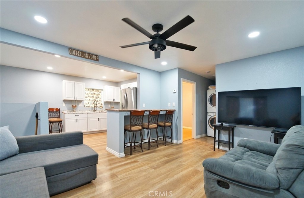 29083 Hook Creek Road Cedar Glen, CA 92321 - Photo 9 of 50 a living room with furniture and a flat screen tv with kitchen view